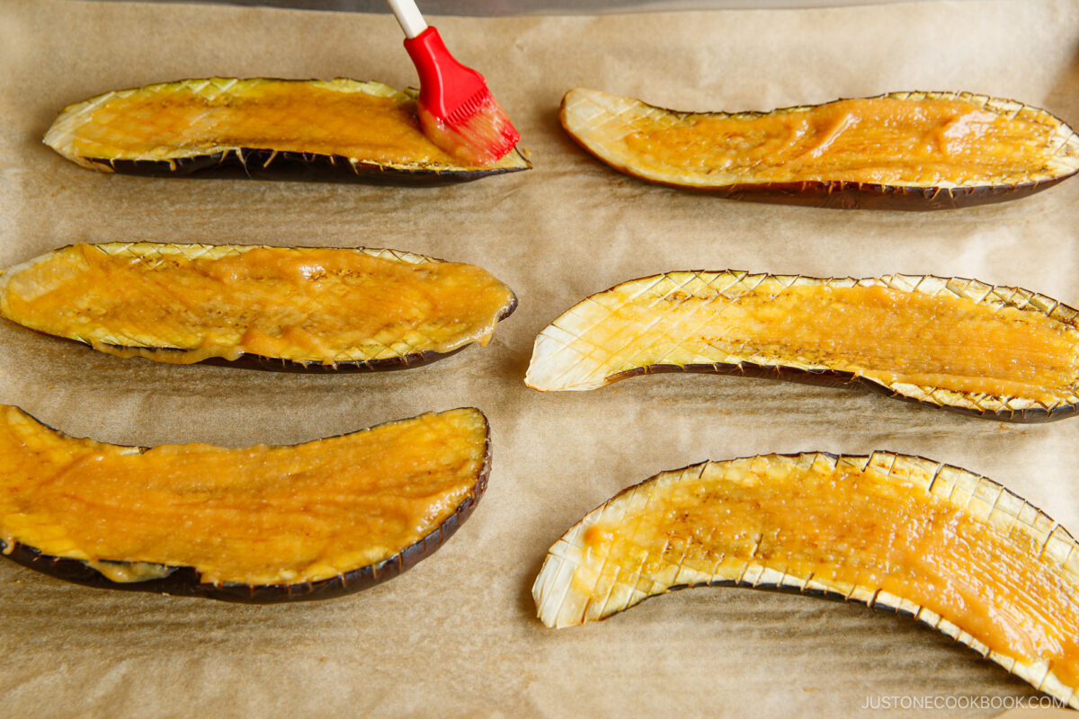 Brushing the miso mixture on the eggplant.